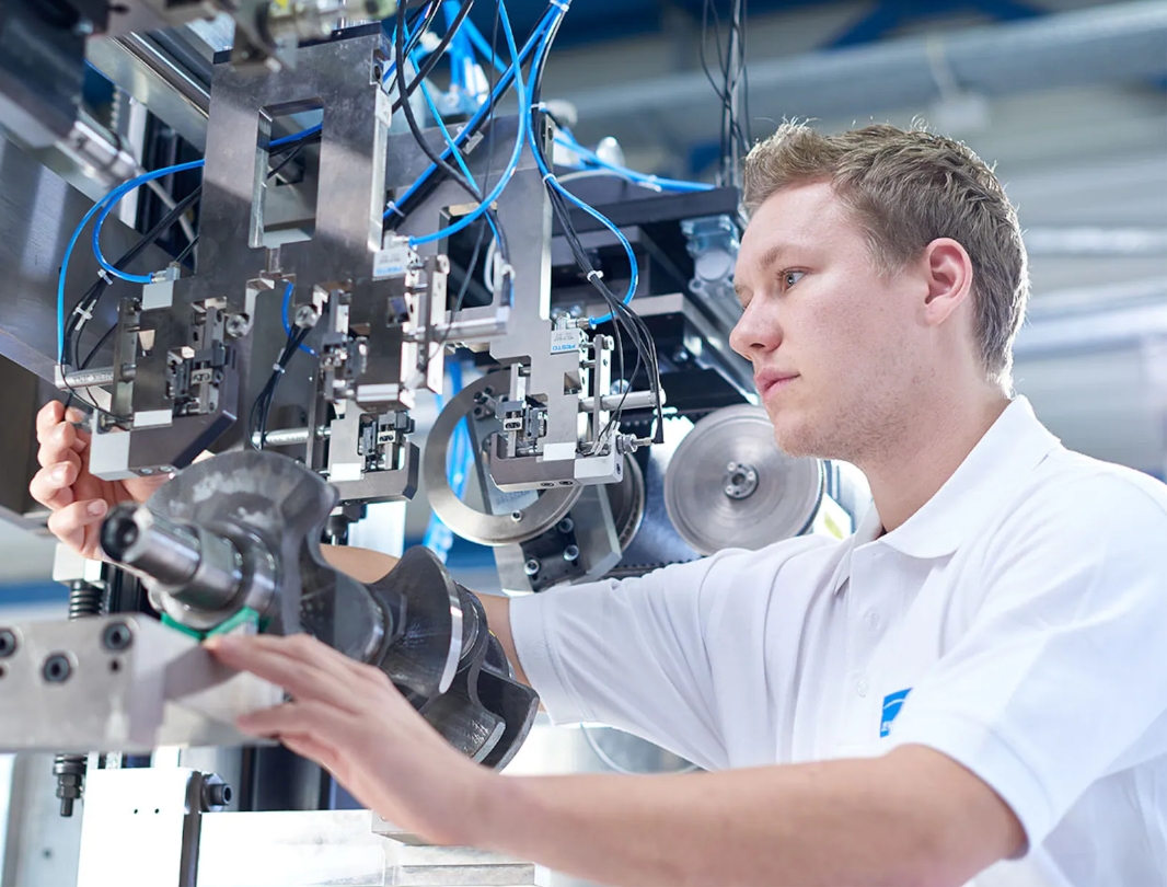 Jenoptik Group Worker over viewing machine mechanisms