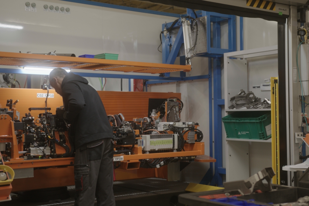 man repairing a machine component