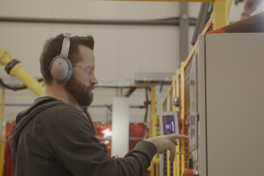 man working on a machine control panel