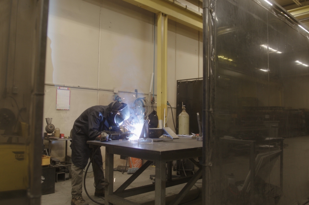 Man welding in Prodomax shop